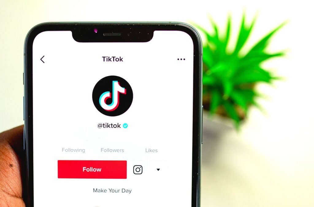 Influencer recording a TikTok video using a smartphone with ring light